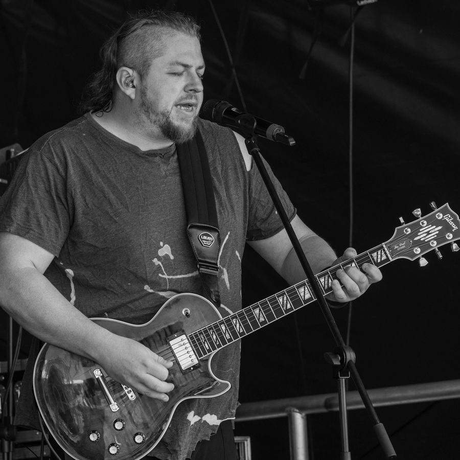 Guitarist singing live, black and white