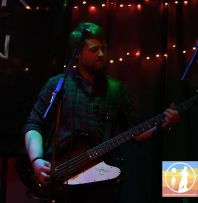 Warrick Emery performing live on bass
